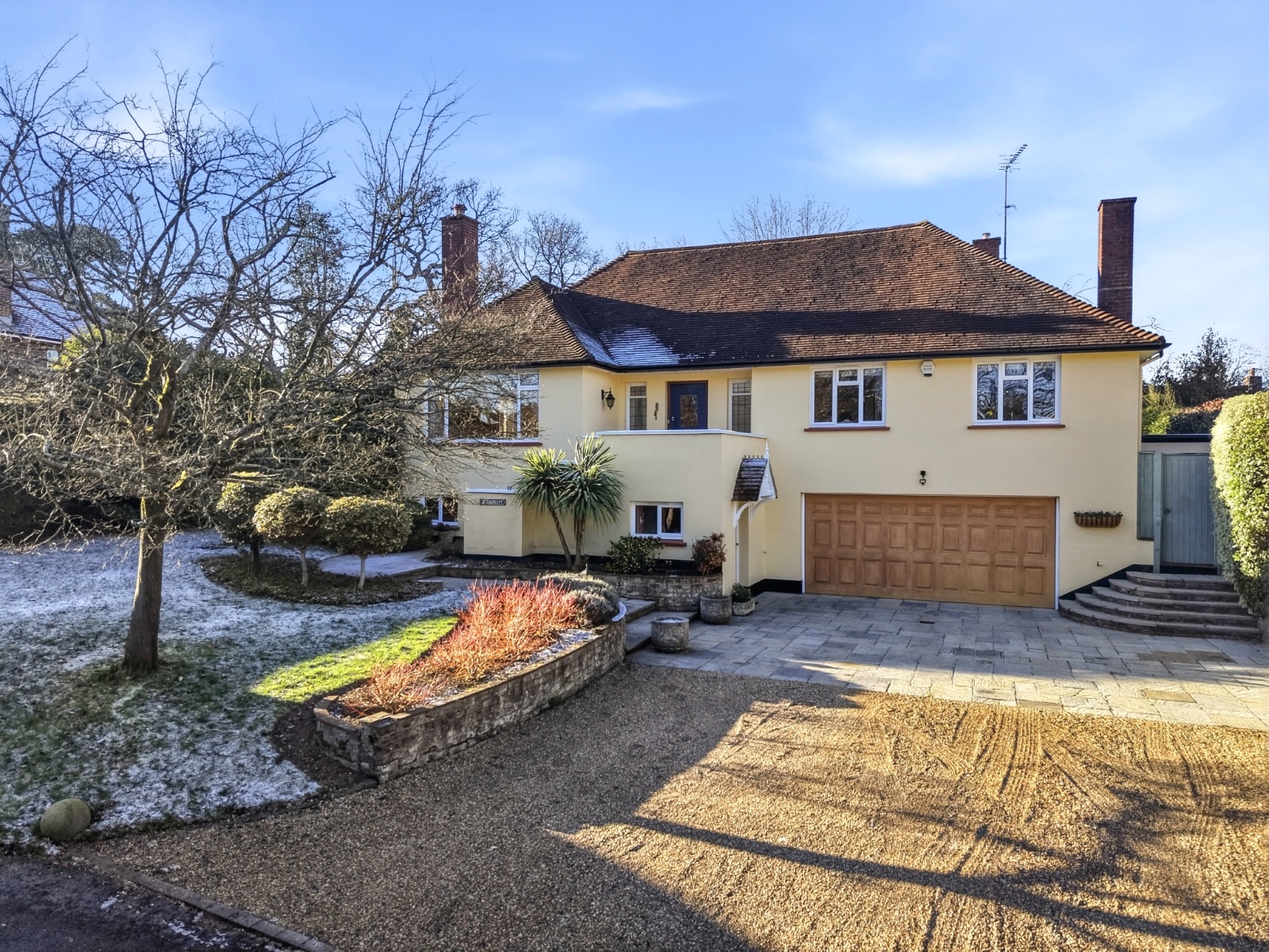 Detached family home in Weybridge with double garage and frosted front garden